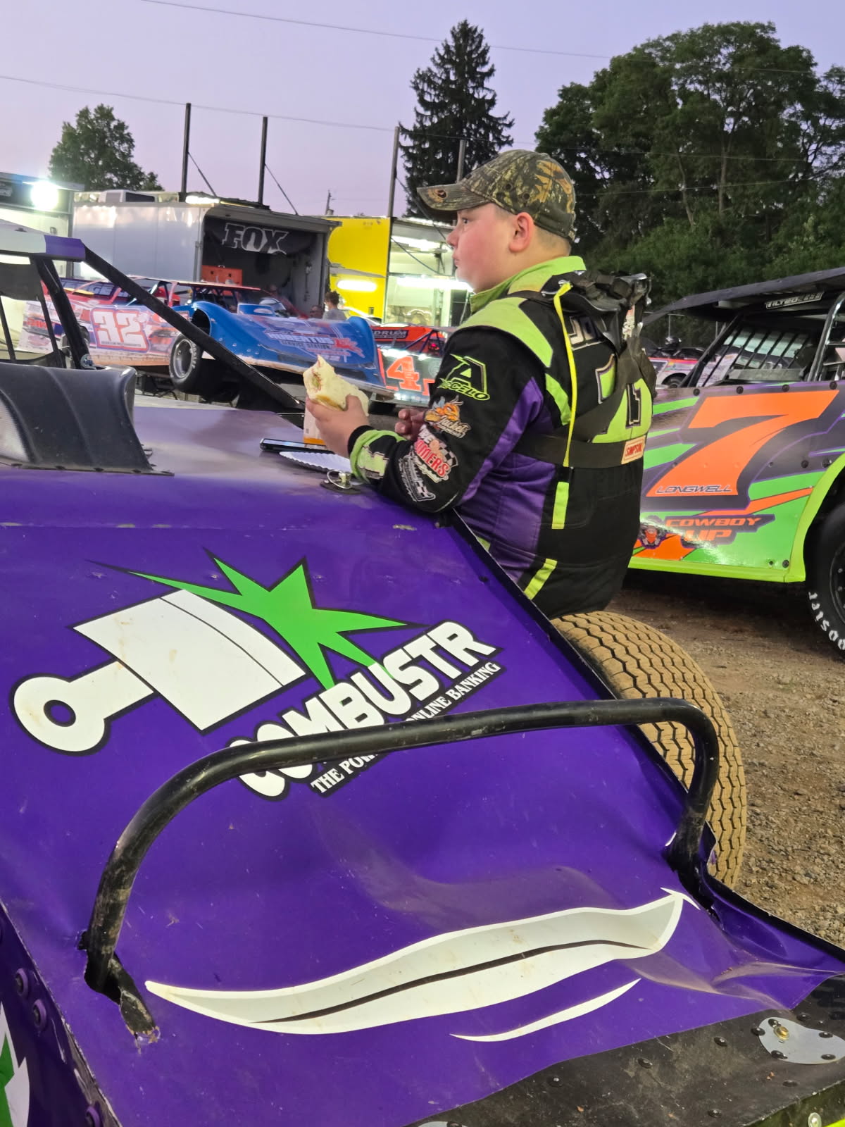 Ryan Johnston in racing suit beside the #11 EconoMod in the pit area 2026