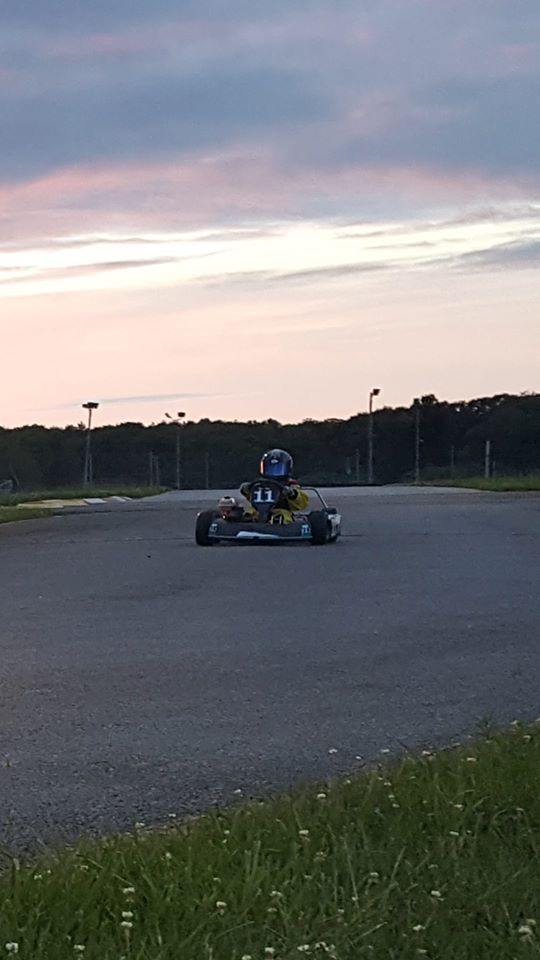 Young Ryan Johnston in #11 go-kart at dusk on Ohio kart track during early racing career