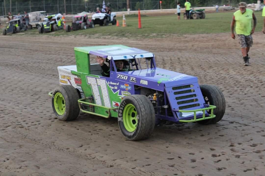 Ryan Johnston waving from #11 EconoMod on dirt track during parade lap