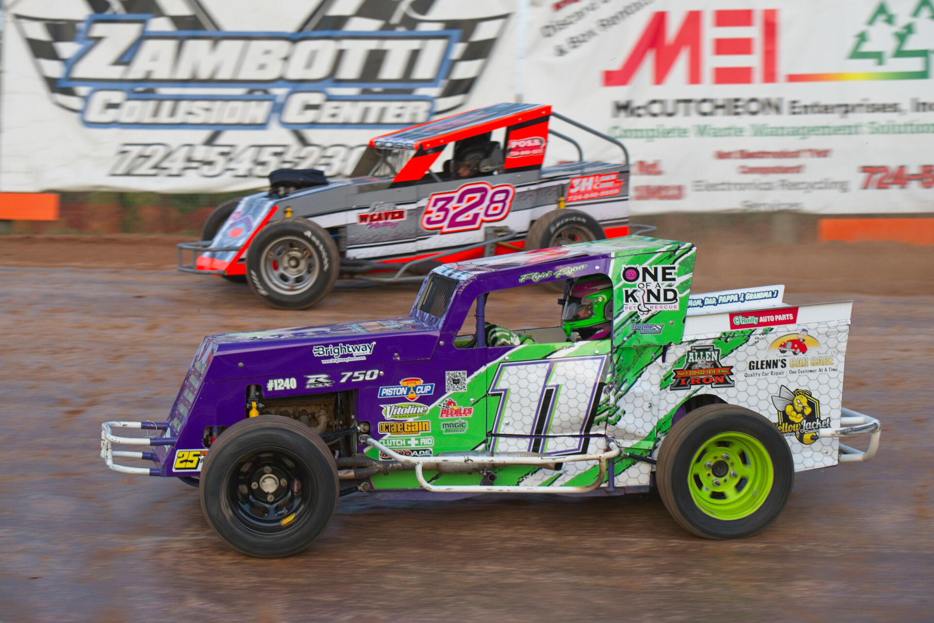 R&R Racing #11 passing competitor on dirt oval during feature race in Ohio