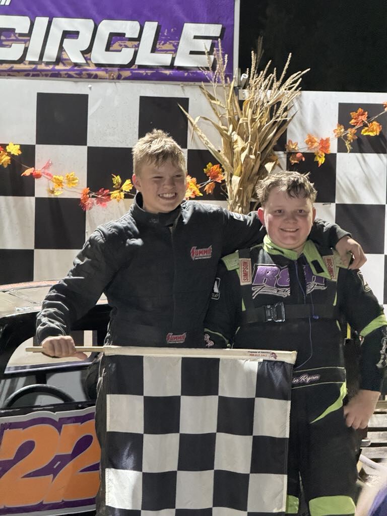 Ryan Johnston celebrating in victory circle with checkered flag at Ohio dirt track