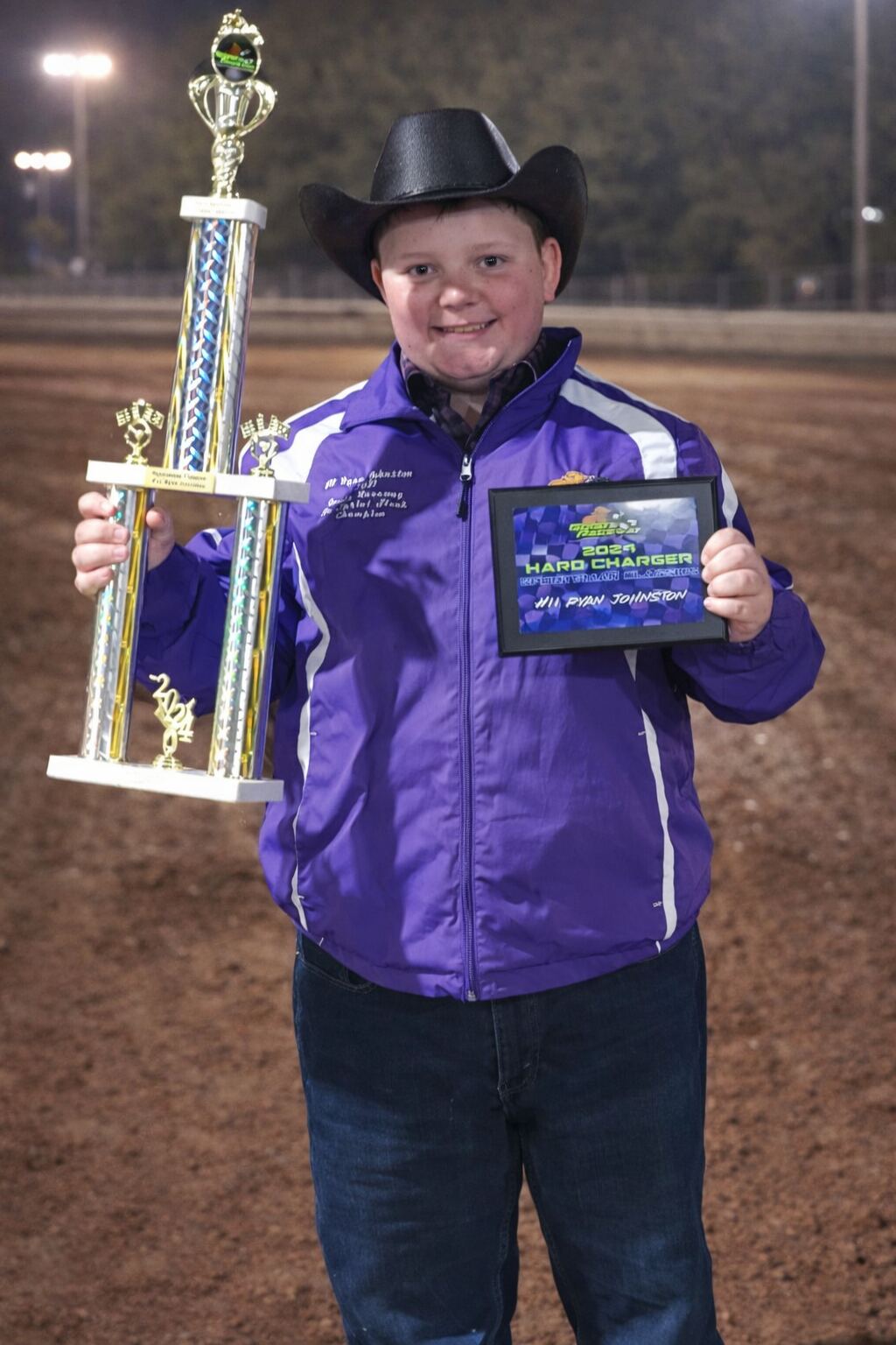 Ryan Johnston holding 2024 Hard Charger trophy at an Ohio dirt track