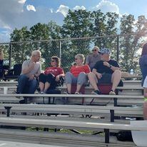 Family watching EconoMod racing from grandstands at Ohio dirt track event