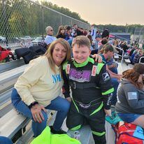 Ryan Johnston in racing suit posing with fan at Ohio dirt track