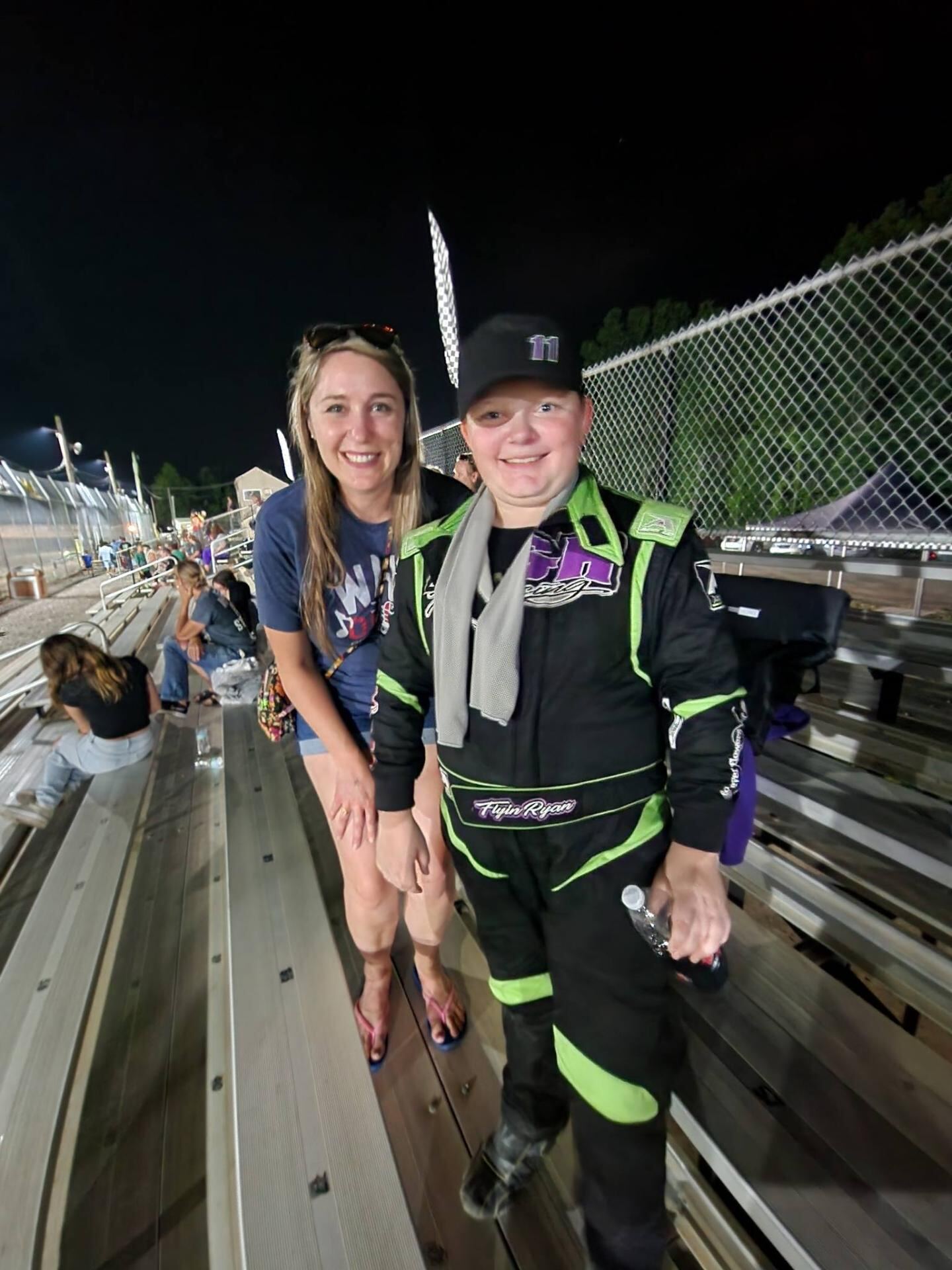 Ryan Johnston #11 posing with fan in racing suit at Ohio dirt track